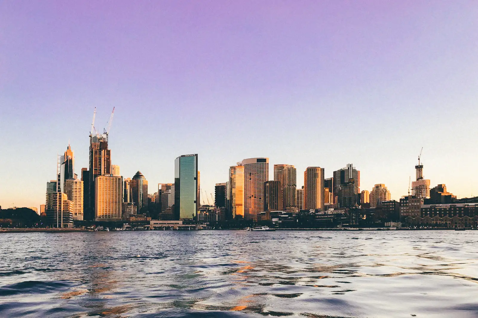 The Sydney skyline across the harbour at golden hour