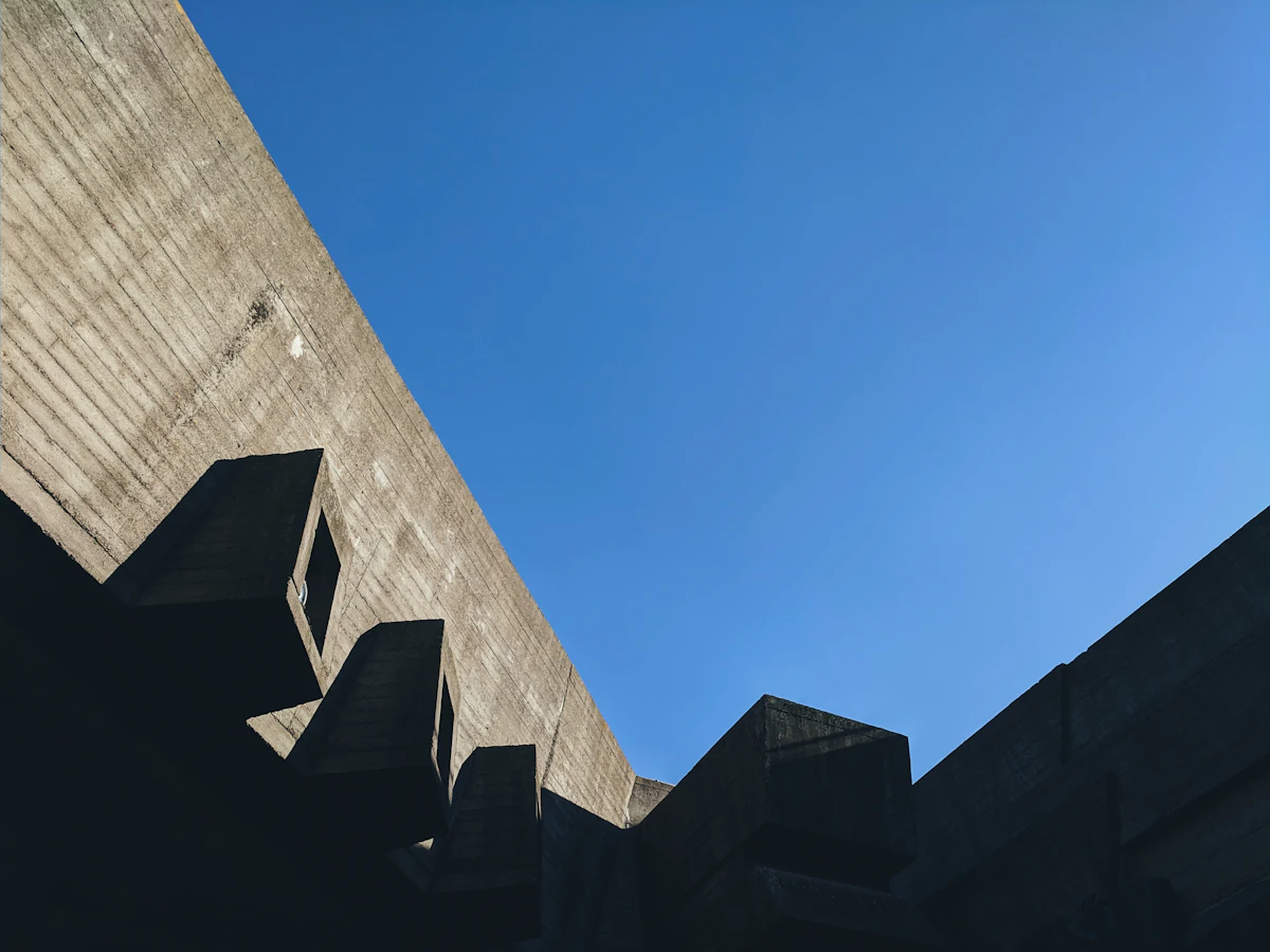 A modern concrete building against a clear blue sky