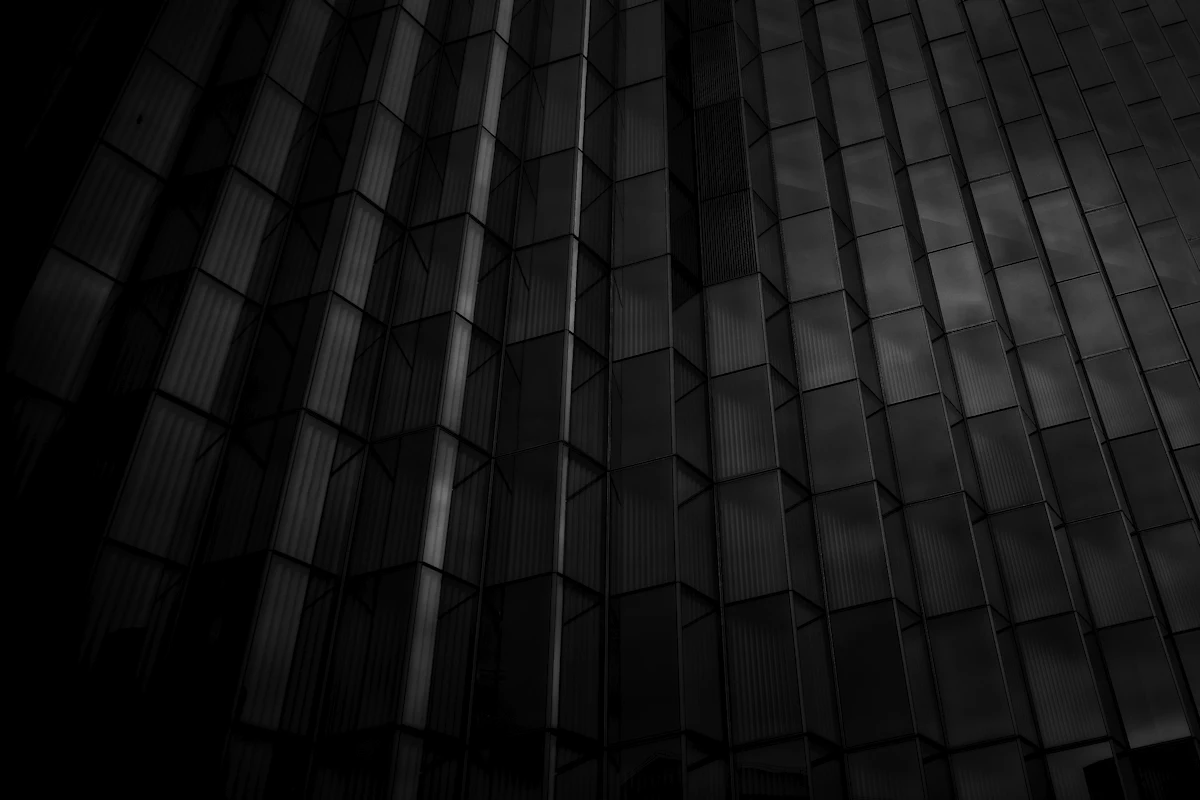 A black and white view of a glass office building